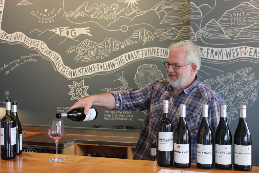 Seth pouring wine at The Valley Project